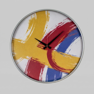 Loravien Vivid Expressionist Art: A massive 50 cm wall clock with a dynamic abstract dial featuring energetic red, yellow, and blue brushstrokes, matte black hands, and a slim red second hand in a sleek metallic frame.